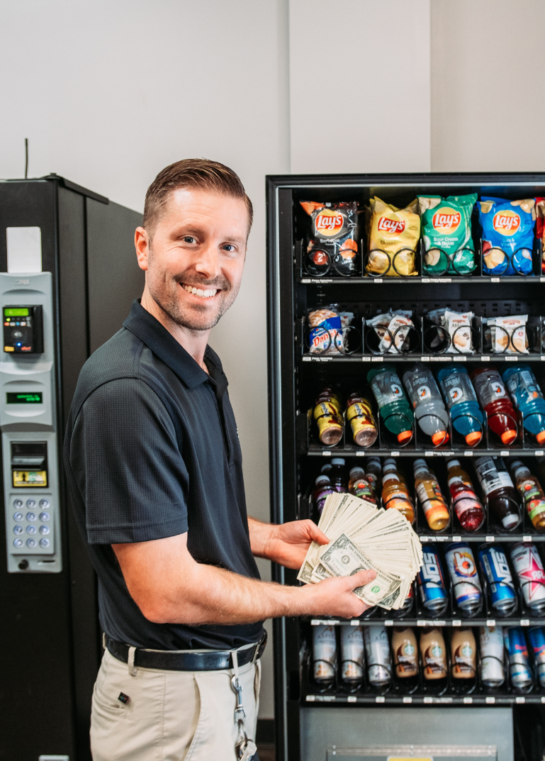 Picture Of Adam Hill In Front of Vending Machine